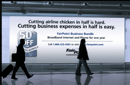 Airport billboard ad for FairPoint Business Bundle saying “Cutting airline chicken in half is hard. Cutting business expenses in half is easy,” with a “50% OFF” badge and silhouettes of travelers walking in front.